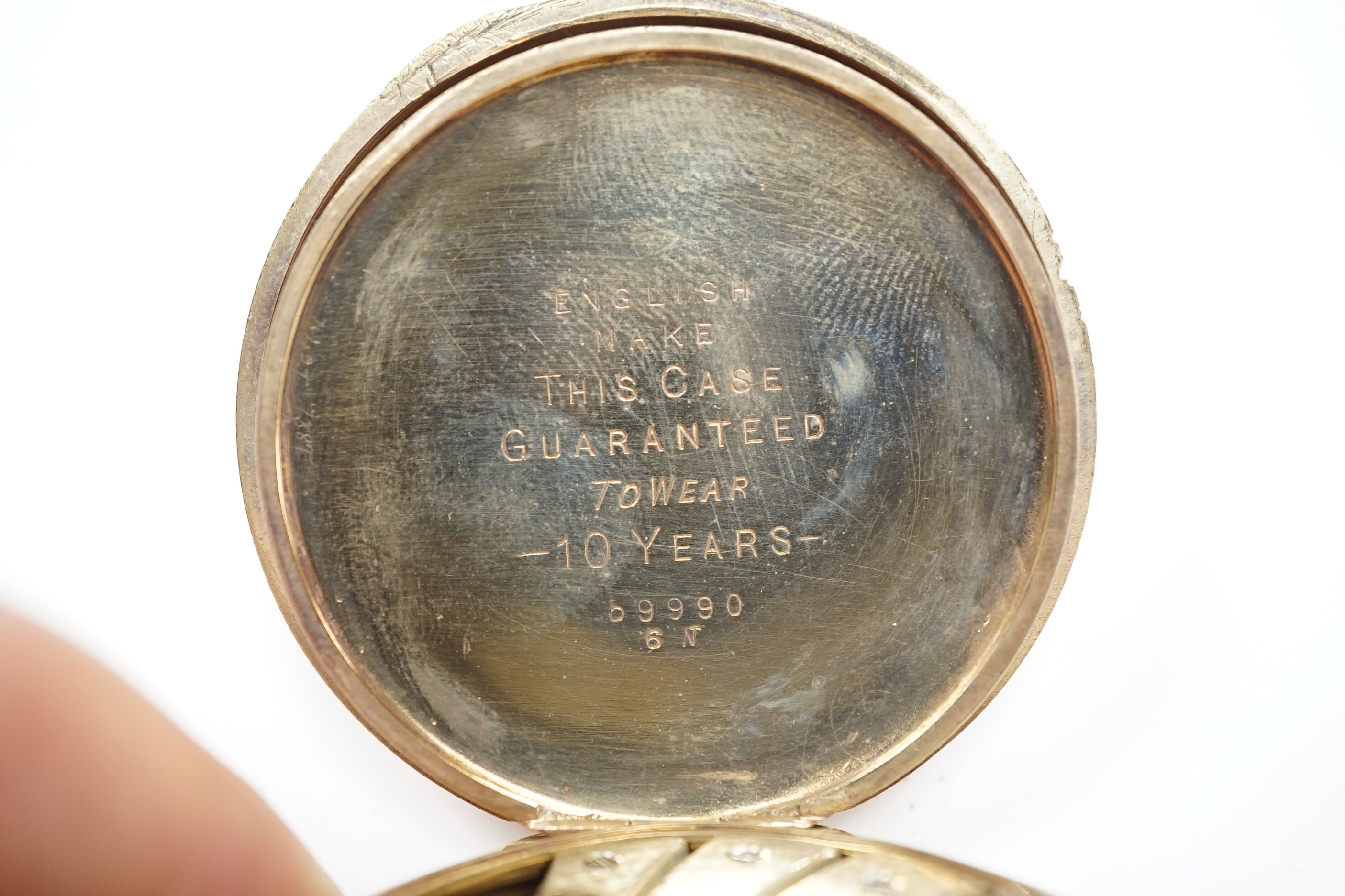 A gold plated Rolex open face keyless pocket watch, with black dial and white Arabic numerals, case diameter 50mm.